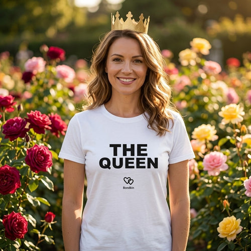 Woman in a white Bondkin The Queen tee and a paper crown among roses